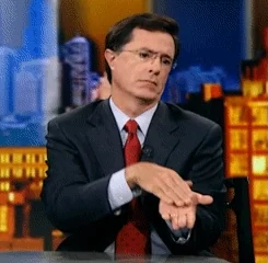 Stephen Colbert giving a deliberately slow clap with a serious expression